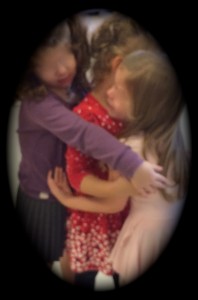 3 girls hugging vignette cut faces edited